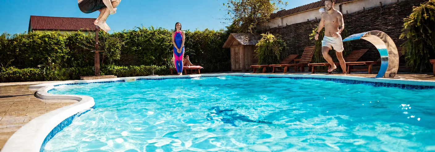 Custom pool and hot tub installation in a landscaped backyard